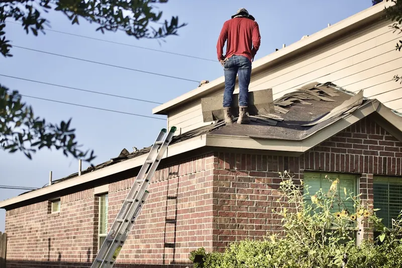 Professional roofer working on a residential roof in North Guilford